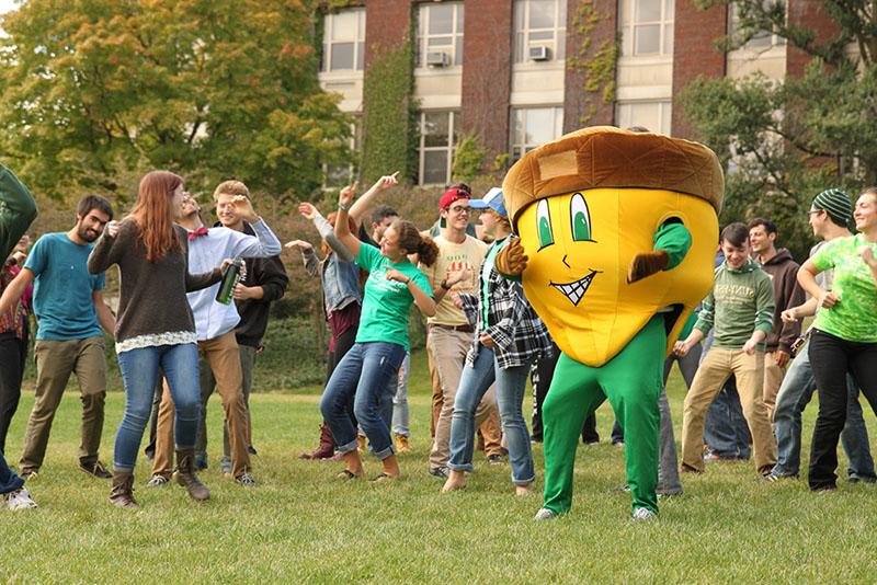 Oakie dances on the quad with students. 